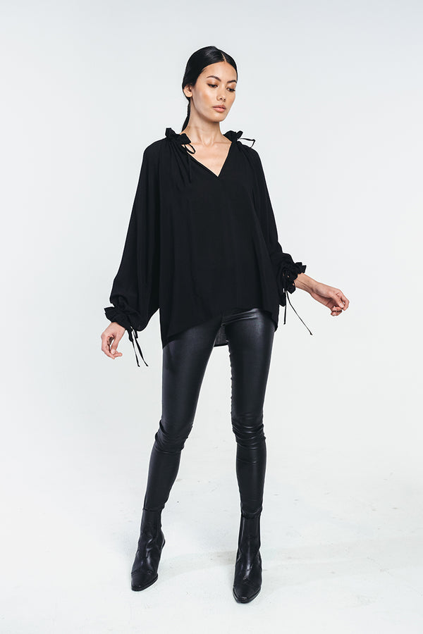 Tundra blouse in black paired with black leather pants. Collar left open to create a v-neckline. Hálo from north